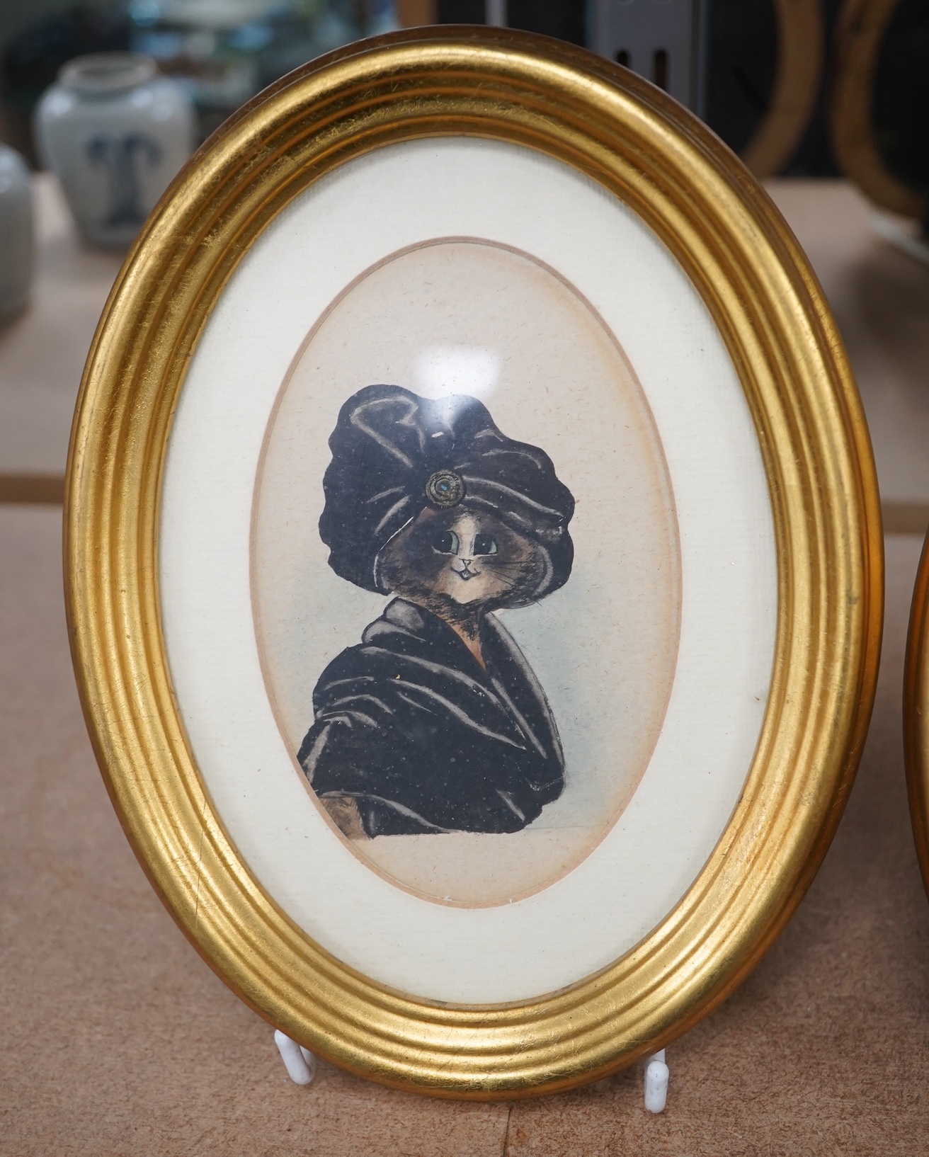 Style of Louis Wain (1860-1939), pair of oval watercolours, Comical studies of cats, 12 x 8.5cm, gilt framed. Condition - fair